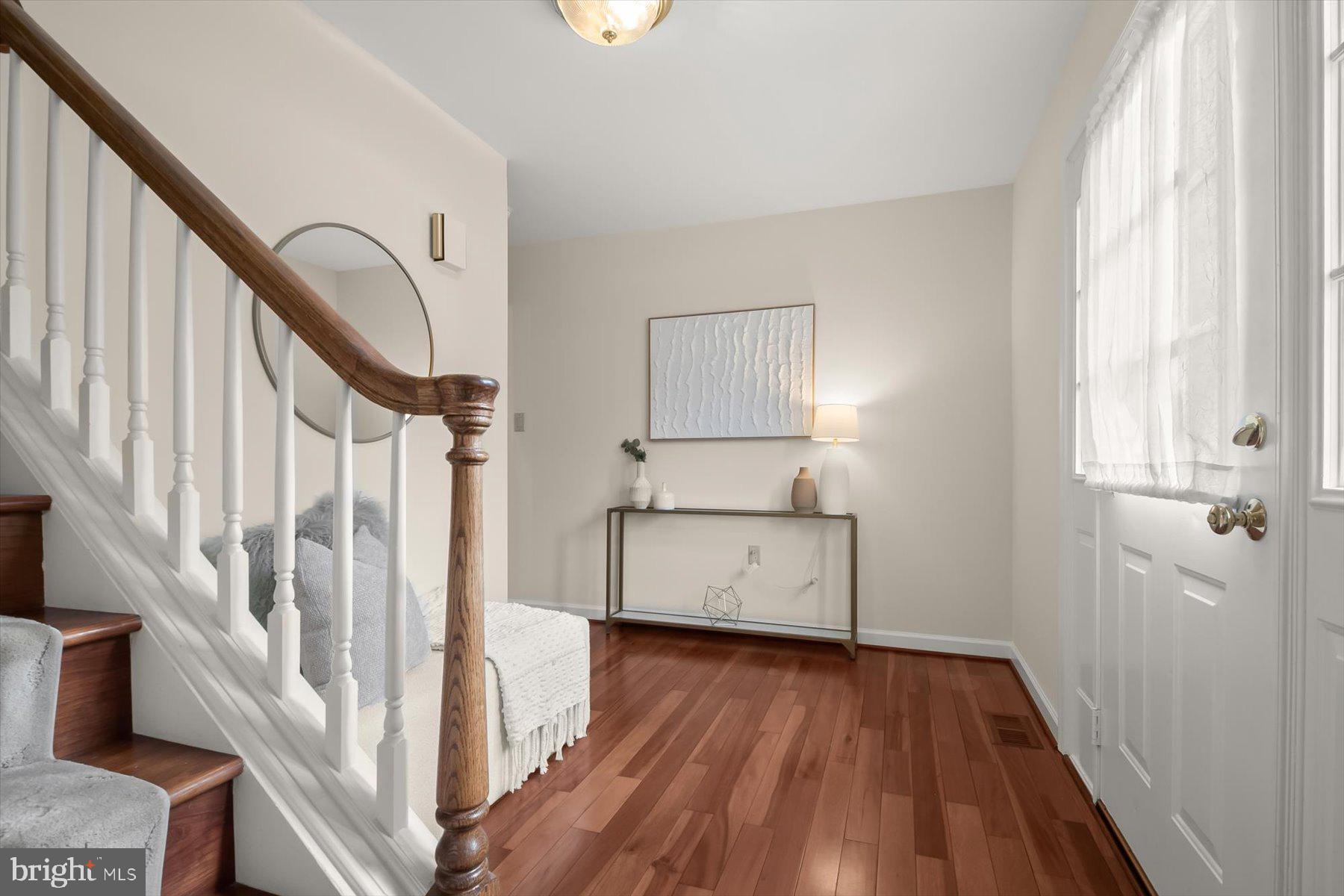 1727 Glastonberry Road Potomac, MD 20854 - Photo 5 of 45 a view of entryway with wooden floor and stairs