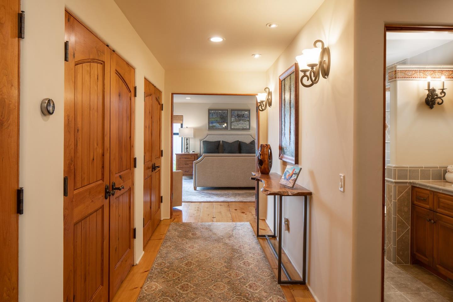 9546 Maple Court Carmel, CA 93923 - Photo 17 of 27 a en suite bathroom with a sink a mirror and shower
