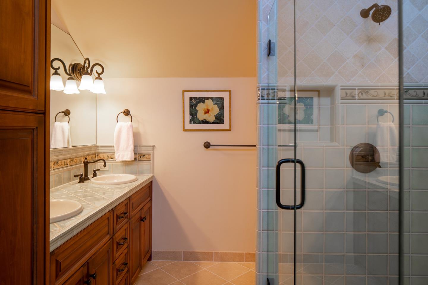 9546 Maple Court Carmel, CA 93923 - Photo 20 of 27 a bathroom with a double vanity sink a toilet a shower and a mirror