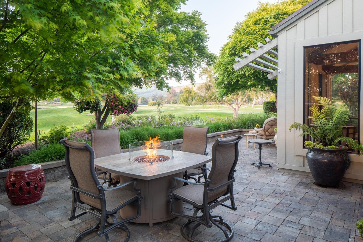 9546 Maple Court Carmel, CA 93923 - Photo 2 of 27 a view of a patio with table and chairs and potted plants