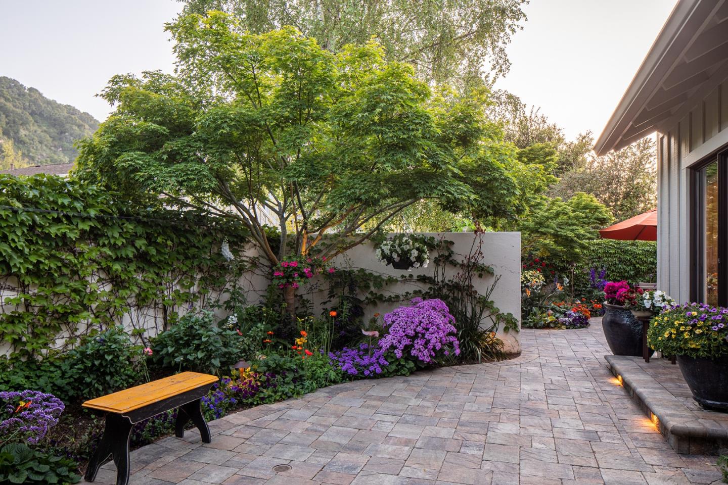 9546 Maple Court Carmel, CA 93923 - Photo 4 of 27 a backyard of a house with lots of green space and a fountain