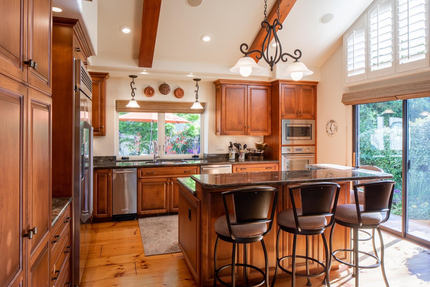 9546 Maple Court Carmel, CA 93923 - Photo 7 of 27 a kitchen with stainless steel appliances granite countertop a sink and a stove