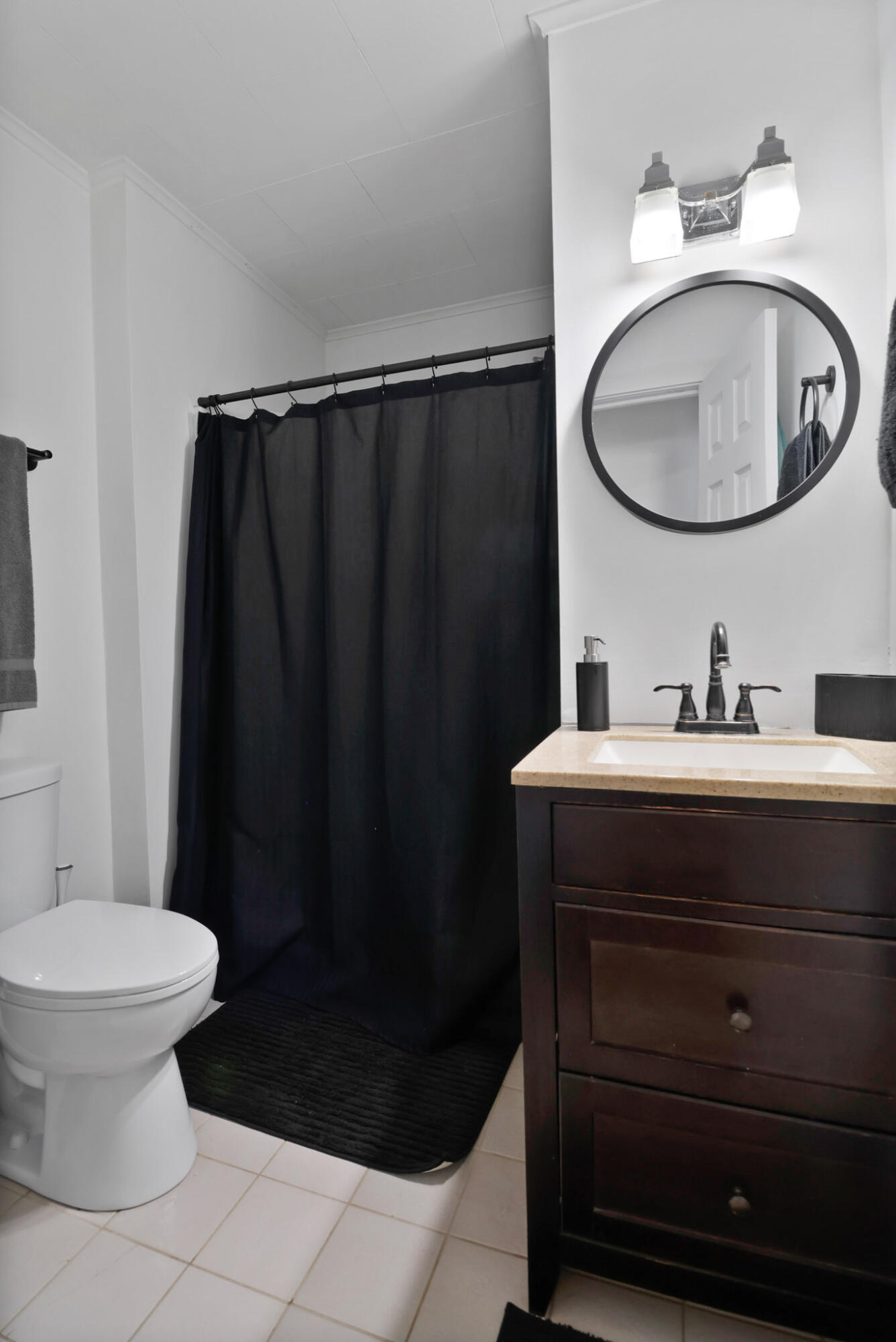 607 Madison Street Valparaiso, IN 46385 - Photo 14 of 15 a bathroom with a sink a toilet and a mirror