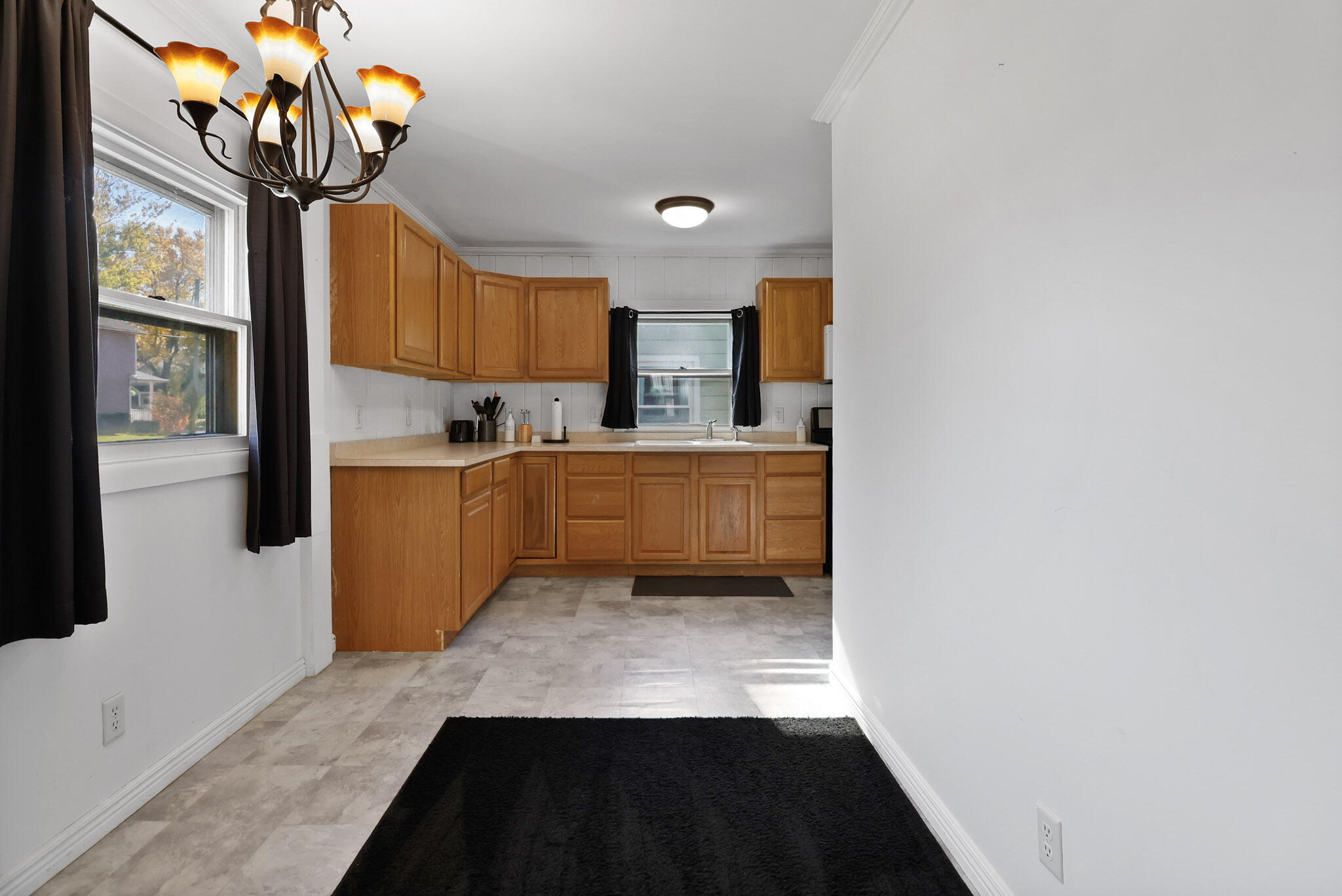 607 Madison Street Valparaiso, IN 46385 - Photo 7 of 15 a kitchen with stainless steel appliances a sink cabinets and a window