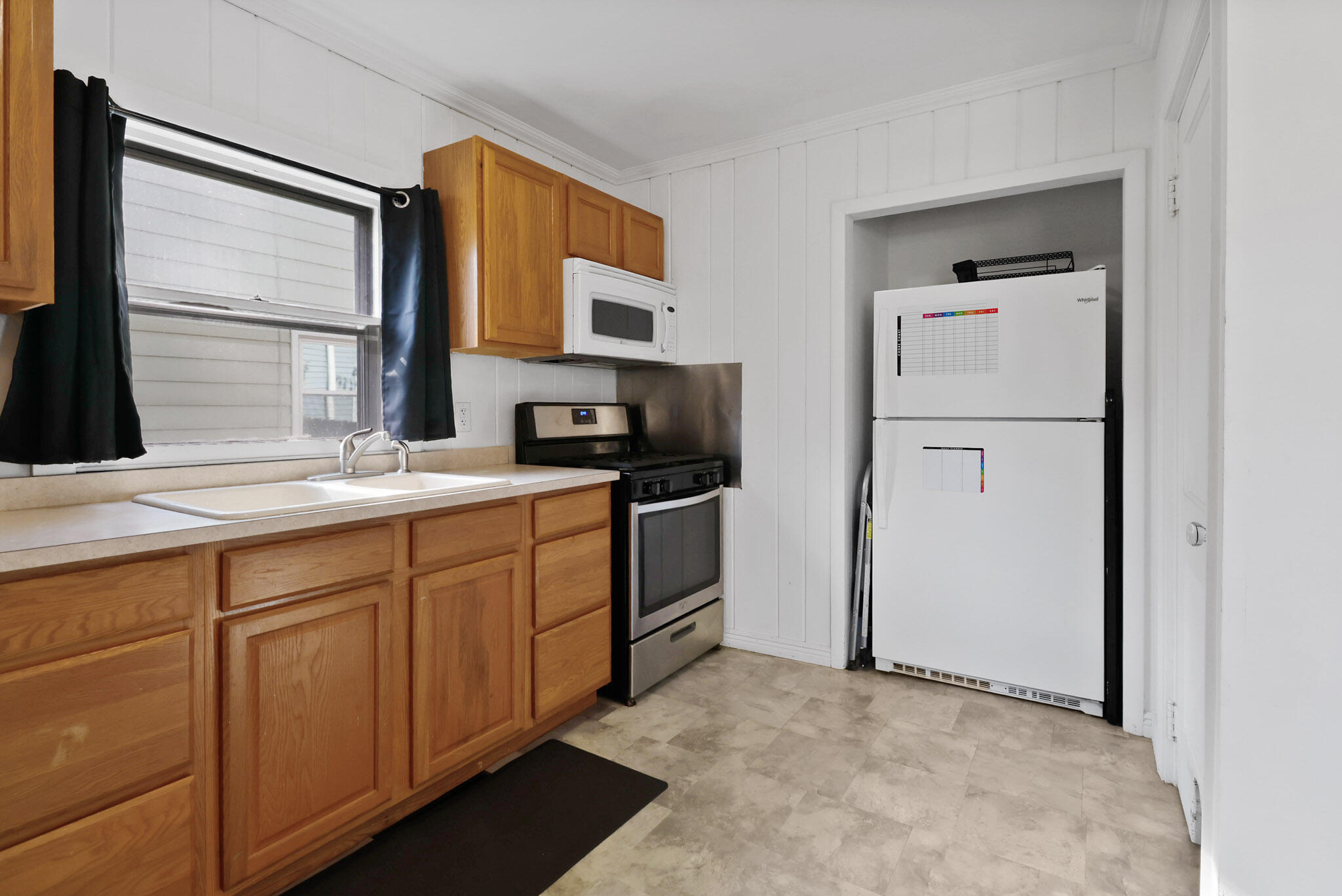 607 Madison Street Valparaiso, IN 46385 - Photo 10 of 15 a kitchen with a refrigerator stove and sink