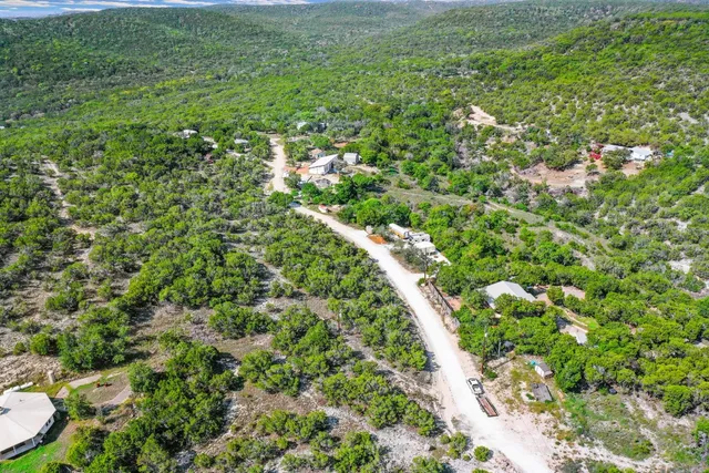 a view of a lush green outdoor space with a lake view
