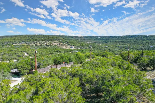 a view of a green field with lots of bushes
