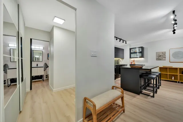 a bedroom with a bed and painting on the wall