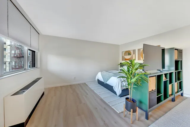 a view of a room that has a mirror and a chair in it