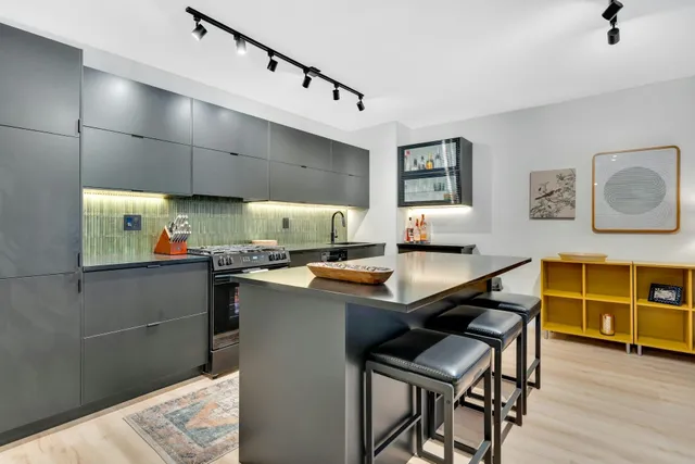 a kitchen with stainless steel appliances a sink dishwasher a stove and a refrigerator