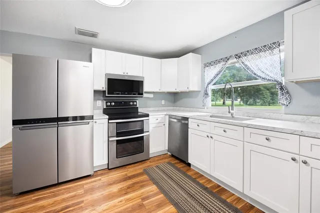 a kitchen with a refrigerator stove and sink