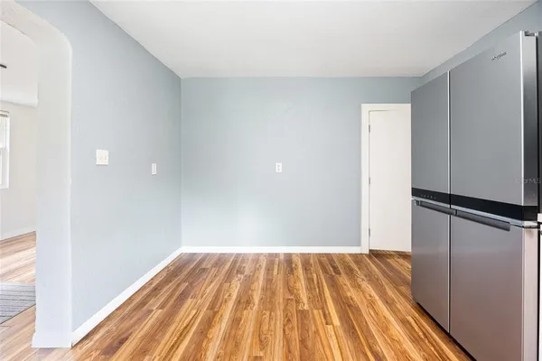 a view of a room with wooden floor