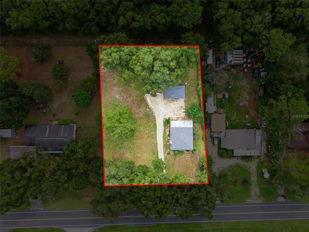 3157 Highway 41 Dunnellon, FL 34432 - Photo 29 of 38 an aerial view of a house with a yard and lake view