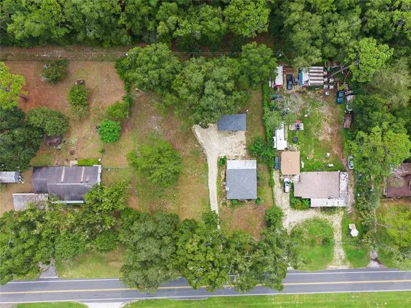 an aerial view of residential house with outdoor space and lake view