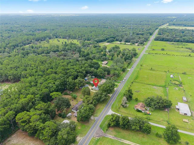 an aerial view of residential houses with outdoor space and street view