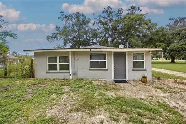 a house with trees in the background