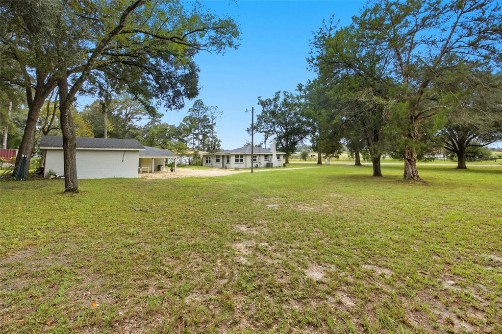 3157 Highway 41 Dunnellon, FL 34432 - Photo 6 of 38 a view of a green field with trees