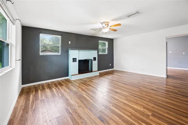 a view of empty room with wooden floor