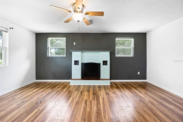 wooden floor in an empty room with a fireplace