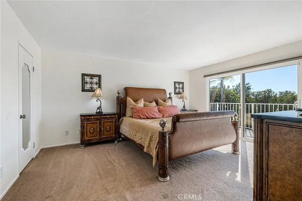 a bed room with a bed and a night stand