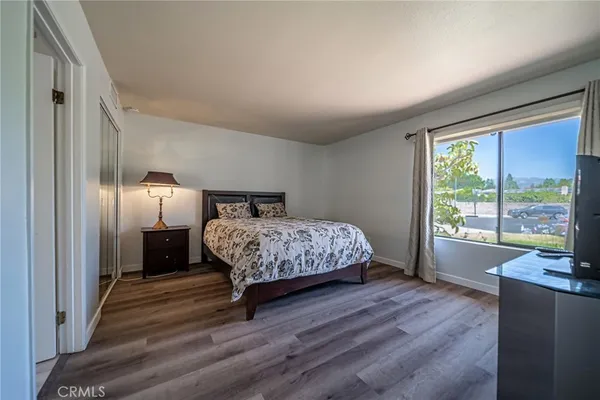 a bedroom with a bed and a large window