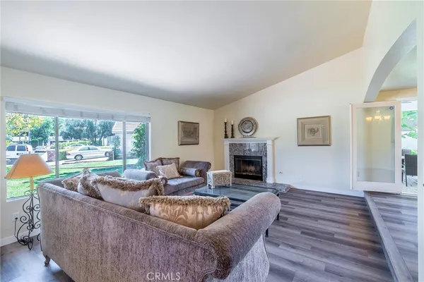 a living room with furniture and a fireplace