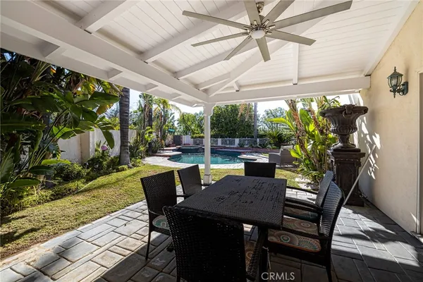 a view of a patio with a table chairs and a backyard