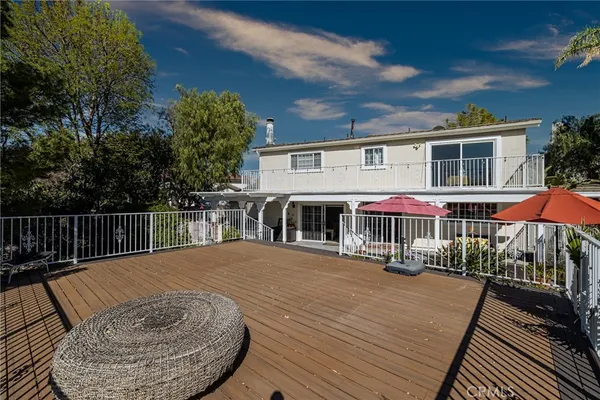 a view of a house with wooden deck