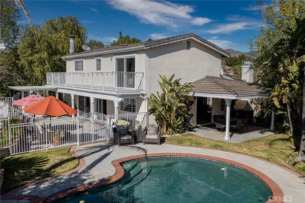 an aerial view of a house with swimming pool and porch