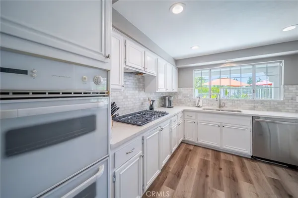 a kitchen with a stove oven and sink