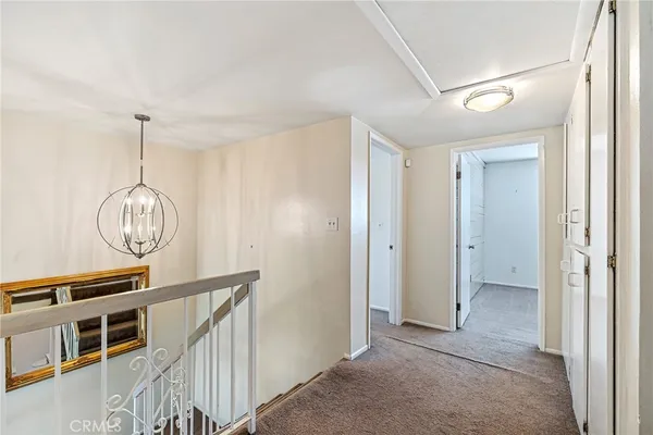 a view of a hallway with wooden floor and workspace
