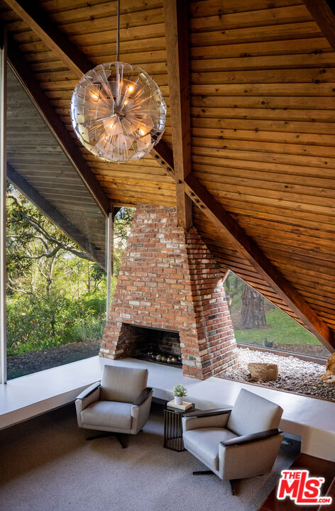 1963 Mandeville Canyon Road Los Angeles, CA 90049 - Photo 21 of 46 a outdoor living space with furniture and a fireplace