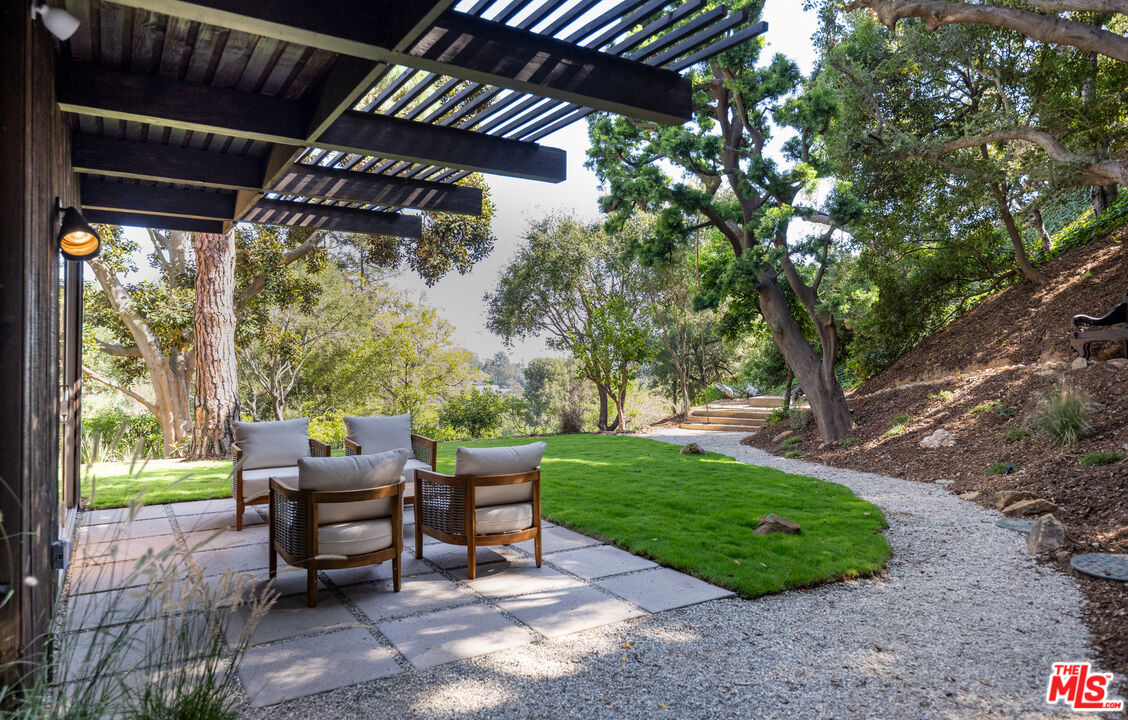 1963 Mandeville Canyon Road Los Angeles, CA 90049 - Photo 35 of 46 a view of a backyard with plants and outdoor seating