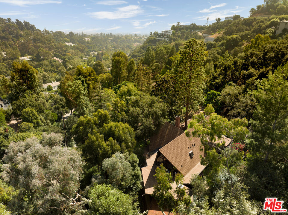 1963 Mandeville Canyon Road Los Angeles, CA 90049 - Photo 44 of 46 an aerial view of a house with a yard