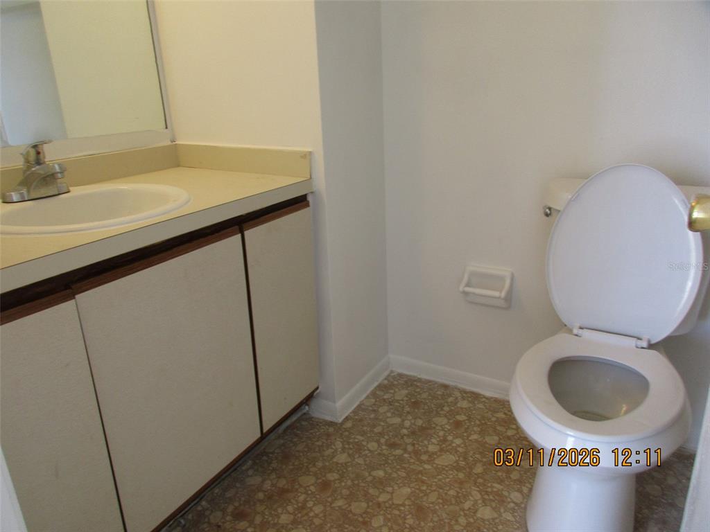 131 Jones Lane, Unit A Kissimmee, FL 34743 - Photo 16 of 23 a bathroom with a sink and a vanity