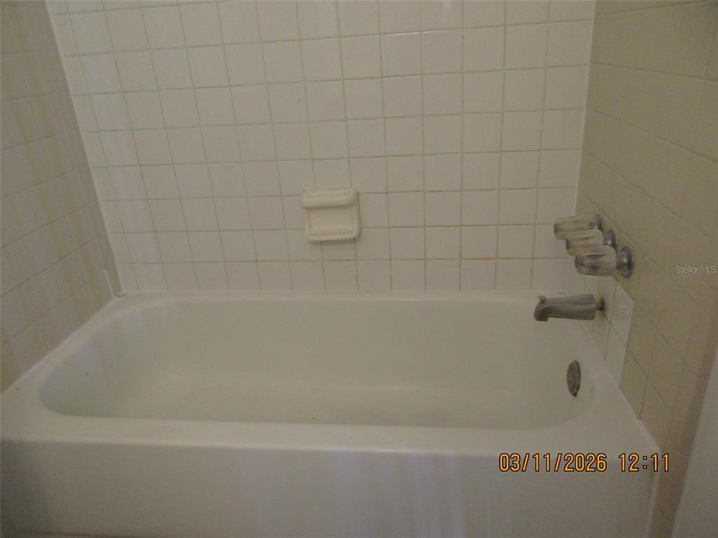 131 Jones Lane, Unit A Kissimmee, FL 34743 - Photo 17 of 23 a close up of a bathtub in a bathroom