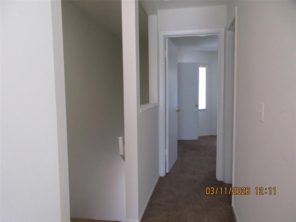 131 Jones Lane, Unit A Kissimmee, FL 34743 - Photo 19 of 23 a view of a livingroom from a hallway