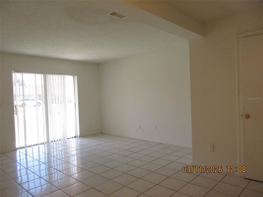 131 Jones Lane, Unit A Kissimmee, FL 34743 - Photo 3 of 23 an empty room with windows