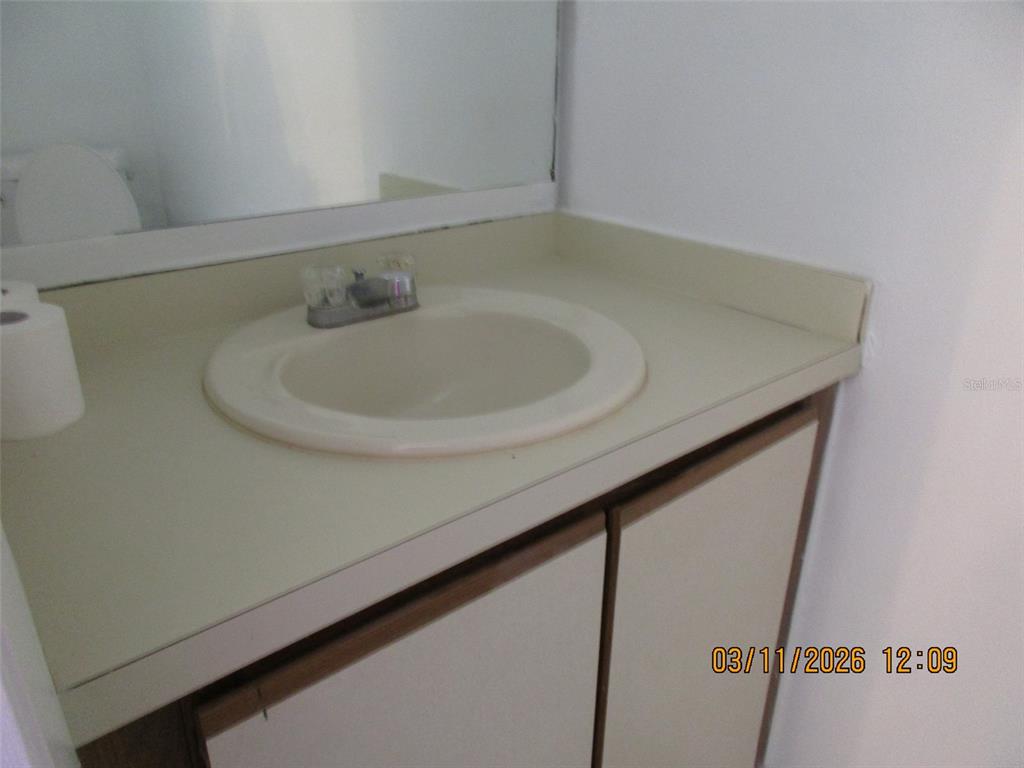 131 Jones Lane, Unit A Kissimmee, FL 34743 - Photo 5 of 23 a bathroom with a sink and a mirror
