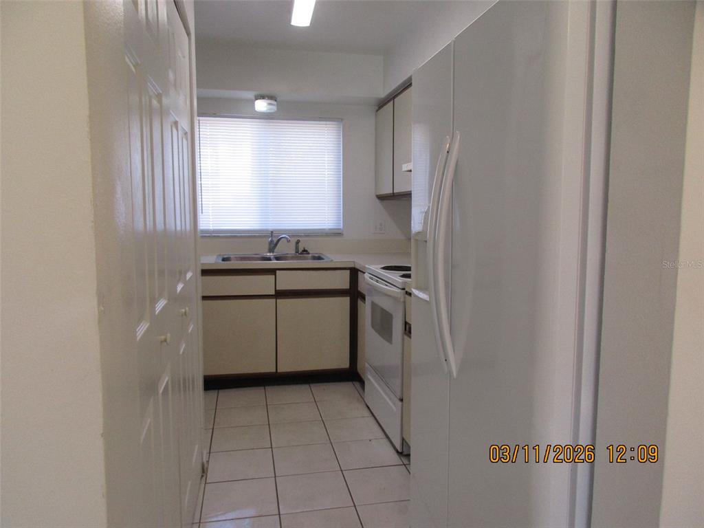 131 Jones Lane, Unit A Kissimmee, FL 34743 - Photo 7 of 23 a view of a kitchen with a sink cabinets and window