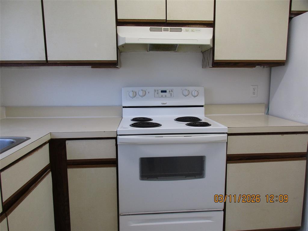 131 Jones Lane, Unit A Kissimmee, FL 34743 - Photo 8 of 23 a stove top oven sitting inside of a kitchen