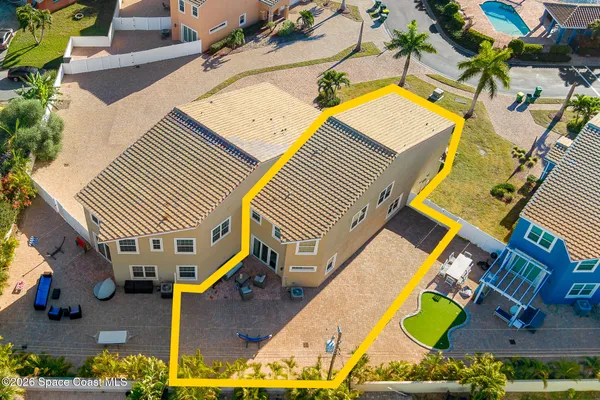 an aerial view of a house with a swimming pool