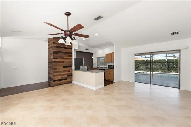 a view of kitchen with furniture and a ceiling fan