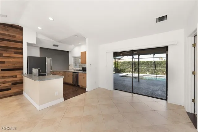 a open kitchen with white cabinets and stainless steel appliances