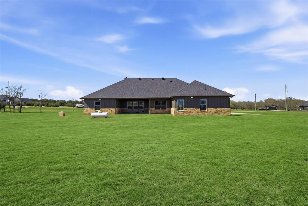6657 Buffalo Ridge Circle Godley, TX 76044 - Photo 26 of 31 a front view of a house with garden