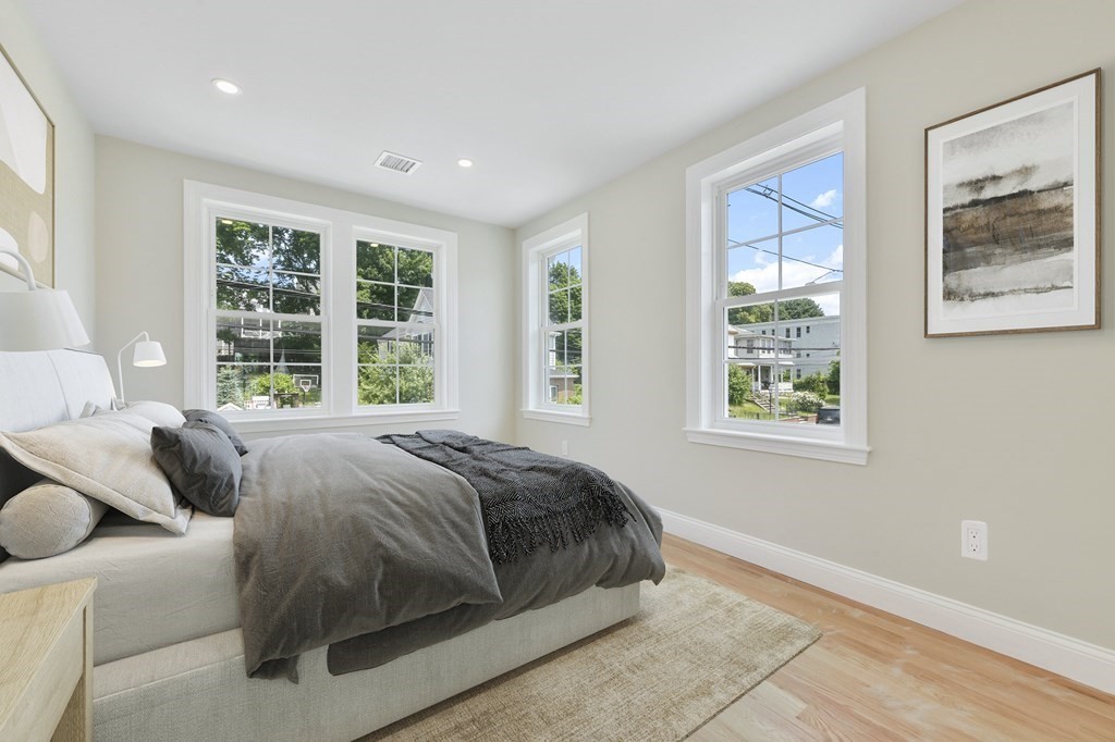 25 Locust Street, Unit 2 Winthrop, MA 02152 - Photo 17 of 29 a bedroom with a bed and glass window