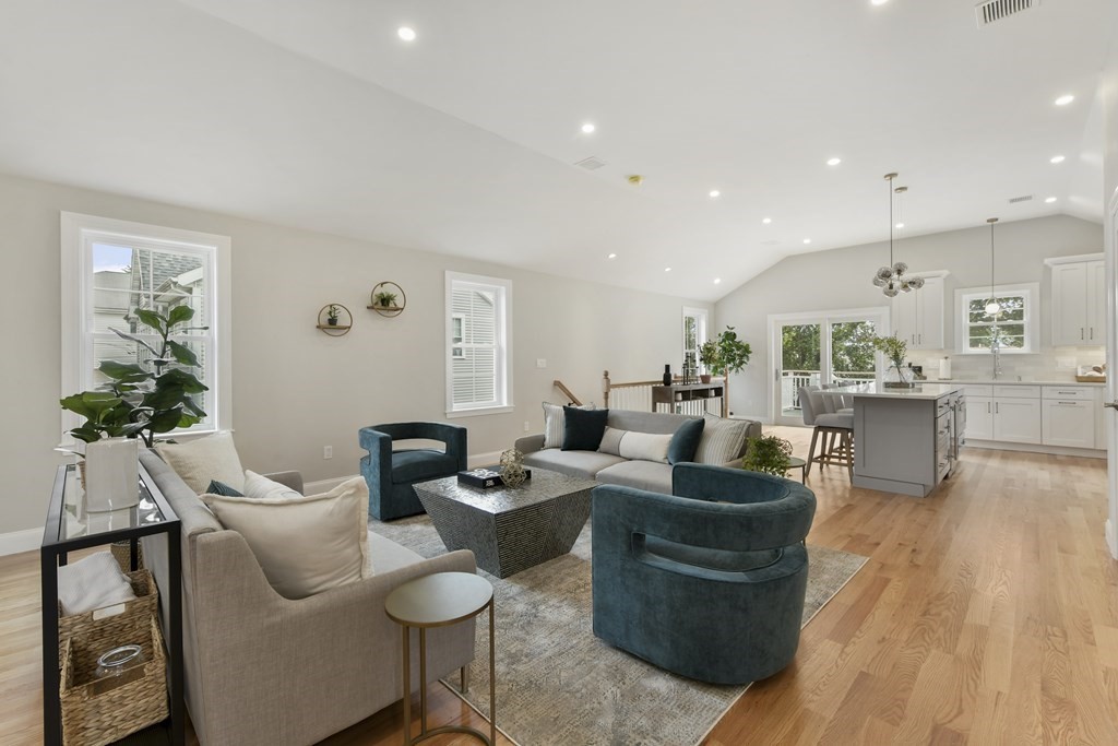 25 Locust Street, Unit 2 Winthrop, MA 02152 - Photo 2 of 29 a living room with furniture potted plant and a wooden floor