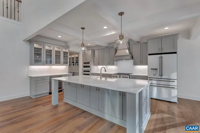 a kitchen with stainless steel appliances granite countertop a sink stove and wooden floor