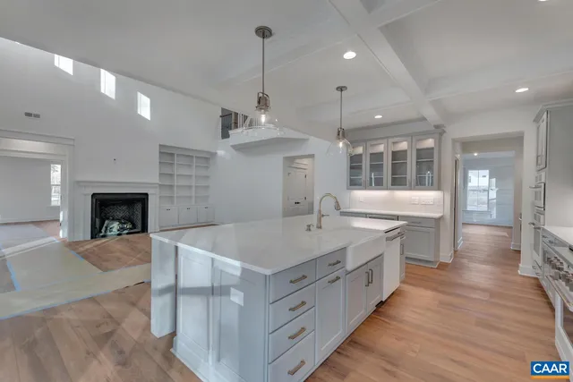 a large kitchen with a center island and stainless steel appliances