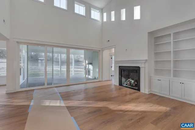 a view of an empty room with a fireplace and a window